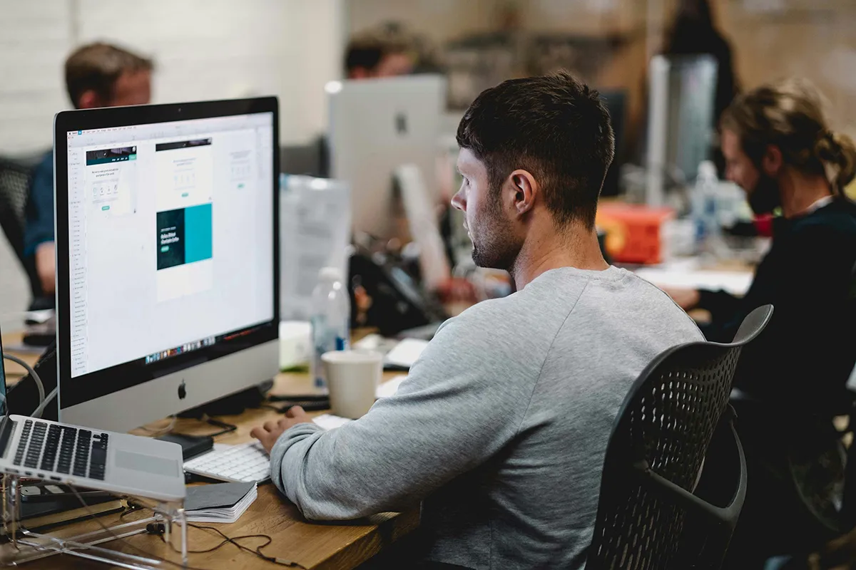 A man working in an office, looking at analytics