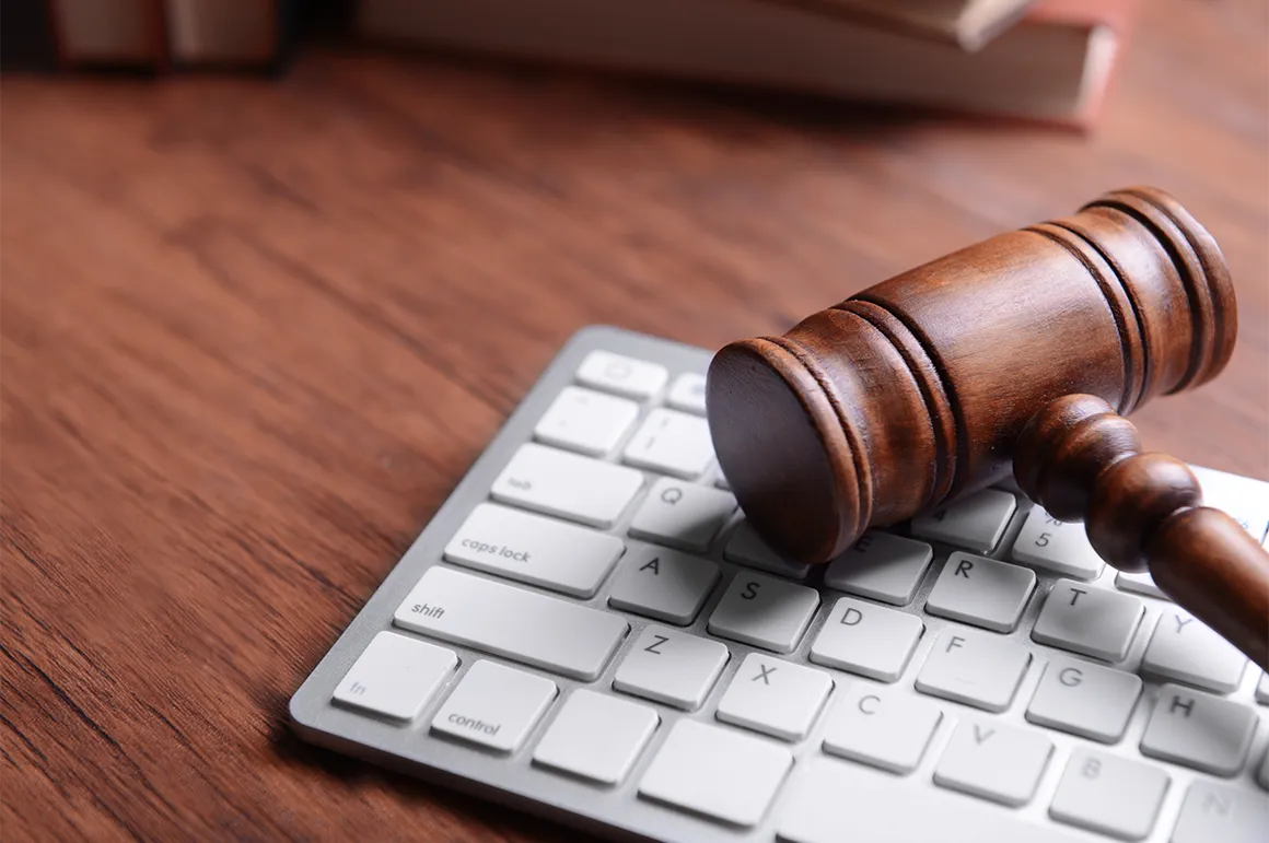 A judges gavel resting on a computer keyboard