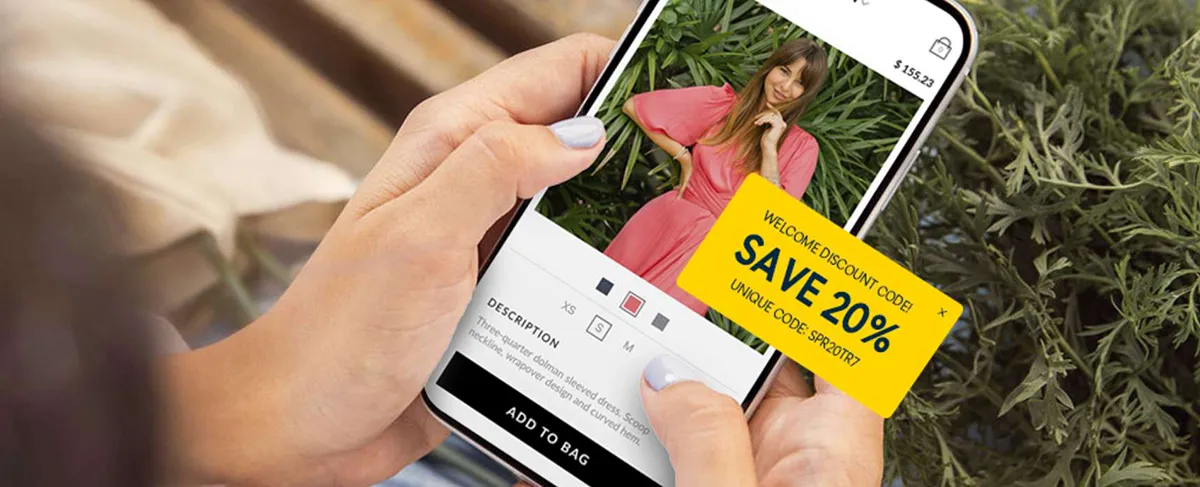 A woman on a smartphone using e-commerce website while a discount offer is popping up