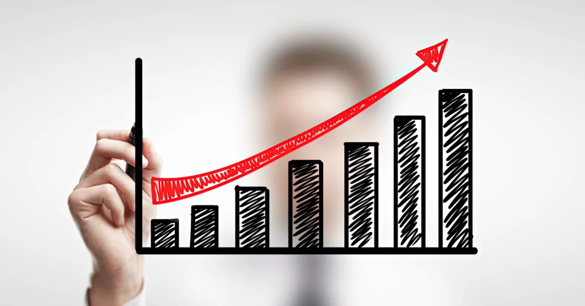 A man drawing a line of growth on a line chart showing business growth