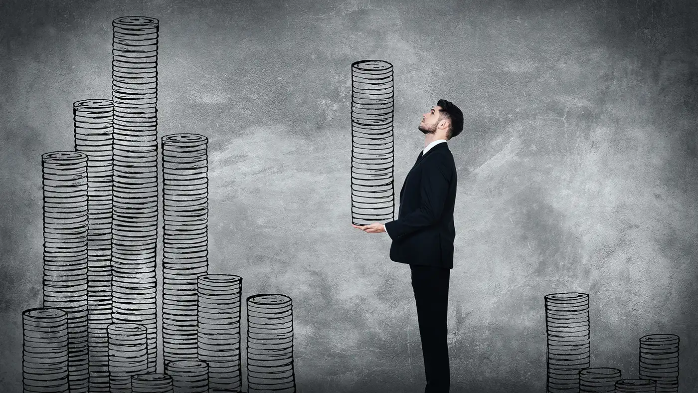 Young man in a full suit carrying an illustrated coin stack